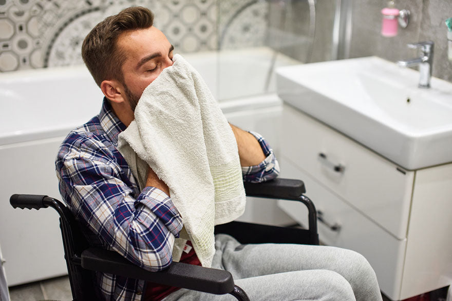 handicapped man washing face bathroom