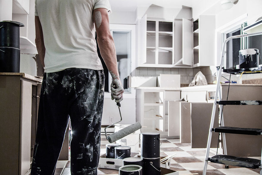 holding paint brush in kitchen