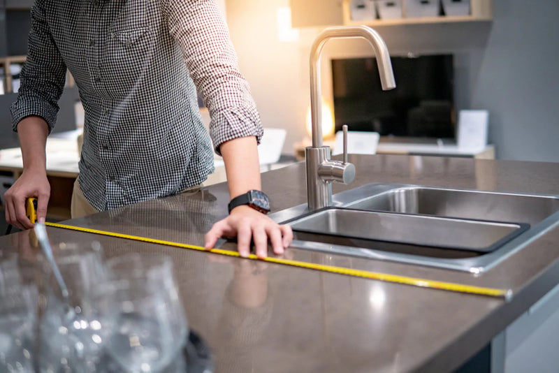 man-using-tape-measure-for-measuring-granite-countertops_800x_webp